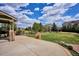 Spacious backyard with a well-manicured lawn, patio, and tasteful landscaping, perfect for outdoor living at 282 N De Gaulle St, Aurora, CO 80018
