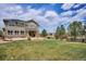Large backyard with a well-maintained lawn, patio, and established trees, creating a serene outdoor space at 282 N De Gaulle St, Aurora, CO 80018