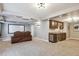 Finished basement featuring a home theater setup and a stylish wet bar area with dark wood cabinetry at 282 N De Gaulle St, Aurora, CO 80018