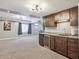 Basement with a wet bar, wooden cabinets, mini fridge, and a spacious seating area for entertaining at 282 N De Gaulle St, Aurora, CO 80018