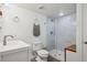 Modern bathroom showcasing a glass-enclosed shower with white subway tile and a wood-look floor at 282 N De Gaulle St, Aurora, CO 80018