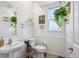 Charming powder room with pedestal sink, decorative mirror, and stylish decor at 282 N De Gaulle St, Aurora, CO 80018