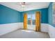 Bright bedroom with wainscotting, large window, and neutral carpeting at 282 N De Gaulle St, Aurora, CO 80018