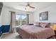 Cozy bedroom with a ceiling fan, large window, and an accent wall, creating a relaxing atmosphere at 282 N De Gaulle St, Aurora, CO 80018
