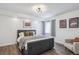 Well-lit bedroom with modern decor, featuring stylish wall art, light-filtering shades, and a cozy sitting chair at 282 N De Gaulle St, Aurora, CO 80018