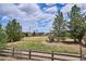 Scenic view of the community park with mature trees, a playground, and lush green space, great for families at 282 N De Gaulle St, Aurora, CO 80018