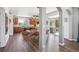 Open-concept dining room connected to kitchen, featuring wood floors, modern lighting, table for six, and sliding glass door at 282 N De Gaulle St, Aurora, CO 80018