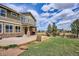 Charming home exterior showcasing a landscaped backyard with a patio, perfect for outdoor entertaining at 282 N De Gaulle St, Aurora, CO 80018
