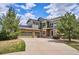 Beautiful two-story home features a stone and siding exterior, a three-car garage, and well-maintained landscaping at 282 N De Gaulle St, Aurora, CO 80018