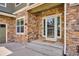 Charming front entrance with a glass door, stone accents, and a welcoming porch, enhancing curb appeal at 282 N De Gaulle St, Aurora, CO 80018