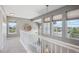 Bright hallway with natural light from multiple windows, neutral paint, and plush carpeting at 282 N De Gaulle St, Aurora, CO 80018
