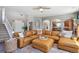 Spacious living room featuring a large sectional, hardwood floors, arched doorways, and seamless flow to kitchen and dining area at 282 N De Gaulle St, Aurora, CO 80018