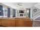 Comfortable living room with hardwood floors, large windows with curtains, fireplace with built-ins, and a spacious sectional at 282 N De Gaulle St, Aurora, CO 80018