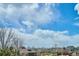 Scenic view of a quiet neighborhood with mature trees and well-maintained homes under a partly cloudy sky at 282 N De Gaulle St, Aurora, CO 80018