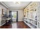 Spacious home office featuring custom built-in shelving, a large window, and plenty of workspace at 282 N De Gaulle St, Aurora, CO 80018