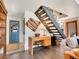 Entryway with a staircase, desk, and blue door, offering a functional and welcoming space at 3817 Ponderosa Dr, Evergreen, CO 80439