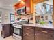 Kitchen with stainless steel stove, and view of the living room at 3817 Ponderosa Dr, Evergreen, CO 80439