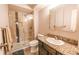 Bright bathroom featuring a walk-in shower with stylish tile and a vanity with a granite countertop at 3460 S Poplar St # 204, Denver, CO 80224