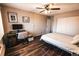 Cozy bedroom with hardwood floors, a ceiling fan, and a built-in closet at 3460 S Poplar St # 204, Denver, CO 80224