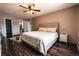 Nicely decorated bedroom featuring wood floors, a neutral palette, and convenient access to the ensuite bathroom at 3460 S Poplar St # 204, Denver, CO 80224