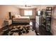 Comfortable bedroom featuring wood floors, a ceiling fan, and a cowhide rug for added texture at 3460 S Poplar St # 204, Denver, CO 80224