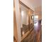 Entryway featuring wood floors, a closet with sliding mirrored doors, and views into an adjacent living space at 3460 S Poplar St # 204, Denver, CO 80224