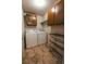 Functional laundry room with a washer, dryer, storage cabinets, and a convenient drying rack at 3460 S Poplar St # 204, Denver, CO 80224