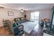 Inviting living room featuring a gray sofa set, ceiling fan, and sliding glass doors to the outside at 3460 S Poplar St # 204, Denver, CO 80224