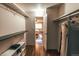 Functional walk-in closet with wood floors, shelves, and hanging space, offering direct access to the bedroom at 3460 S Poplar St # 204, Denver, CO 80224