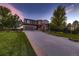 Inviting two-story home with a long driveway, three-car garage and mature trees at 25601 E Indore Dr, Aurora, CO 80016