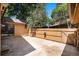 Private backyard featuring a stamped concrete patio, wood fence, and mature trees at 136 S Eagle Cir, Aurora, CO 80012