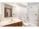 Bathroom showcasing sink with wood vanity, tiled shower with bathtub, and updated finishes at 136 S Eagle Cir, Aurora, CO 80012