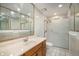Bathroom featuring tiled shower, a sink and vanity, and white tile floors at 136 S Eagle Cir, Aurora, CO 80012