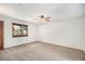 Bedroom boasts neutral carpet and a large window, providing ample light at 136 S Eagle Cir, Aurora, CO 80012