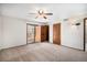 Bedroom featuring carpet, ceiling fan, slider doors, and two closets at 136 S Eagle Cir, Aurora, CO 80012