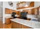 Functional kitchen featuring a center island with bar seating, modern appliances, and ample counter space at 136 S Eagle Cir, Aurora, CO 80012