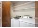 Bright laundry room featuring a new side-by-side washer and dryer at 136 S Eagle Cir, Aurora, CO 80012