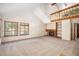 Spacious living room with vaulted ceilings, a fireplace, large windows, and a cozy atmosphere at 136 S Eagle Cir, Aurora, CO 80012