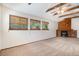 Cozy living room features a brick fireplace, wood beams, and three windows for natural light at 136 S Eagle Cir, Aurora, CO 80012