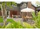 Inviting backyard with stone patio, modern furniture, and a charming fire pit for outdoor gatherings at 10000 E Ohio Ave, Denver, CO 80247