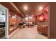 Finished basement with a cozy seating area, bar and adjacent office space at 10000 E Ohio Ave, Denver, CO 80247