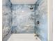 Modern bathroom featuring blue marble tile and bronze fixtures in the shower area at 10000 E Ohio Ave, Denver, CO 80247