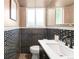 Powder room featuring bold black and white tiling and a sleek modern sink and vanity at 10000 E Ohio Ave, Denver, CO 80247