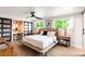 Bright bedroom with wood floors, ceiling fan, and dressing table nook at 10000 E Ohio Ave, Denver, CO 80247