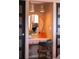 Close-up of a vanity with round mirror and lighting in a dressing area at 10000 E Ohio Ave, Denver, CO 80247