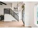 Inviting entryway with decorative staircase and contemporary decor, enhanced by natural light and stylish flooring at 10000 E Ohio Ave, Denver, CO 80247