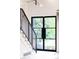 Bright entryway featuring steel staircase and abundant natural light through a large window at 10000 E Ohio Ave, Denver, CO 80247