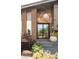 Modern front entrance with updated door, stone accents, beautiful landscaping, and contemporary light fixture at 10000 E Ohio Ave, Denver, CO 80247