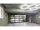 Modern garage with a glass door, organized storage, and bright lighting, creating a functional space at 10000 E Ohio Ave, Denver, CO 80247
