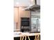 Close-up of a modern kitchen with stainless steel oven, range, refrigerator, and lovely wood cabinets at 10000 E Ohio Ave, Denver, CO 80247
